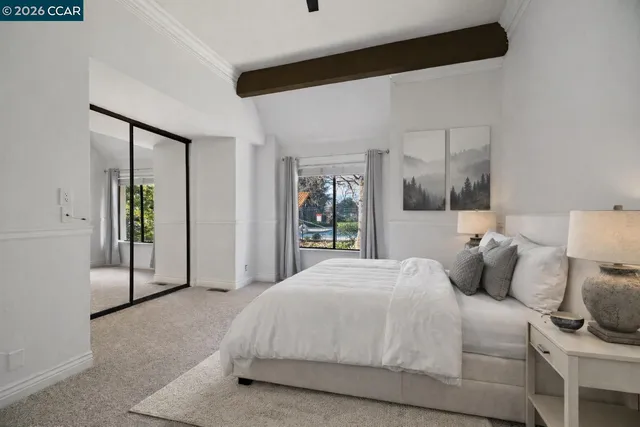 a bedroom with a large bed and a large window