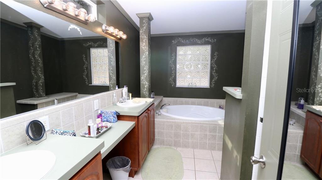 4873 Old Ranch Road Sarasota, FL 34241 - Photo 38 of 49 Master bath with big soaking tub, dual sinks, and (not visible) separate shower stall