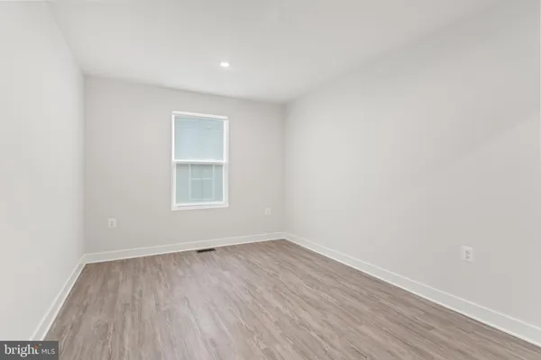 a view of a room with wooden floor and window