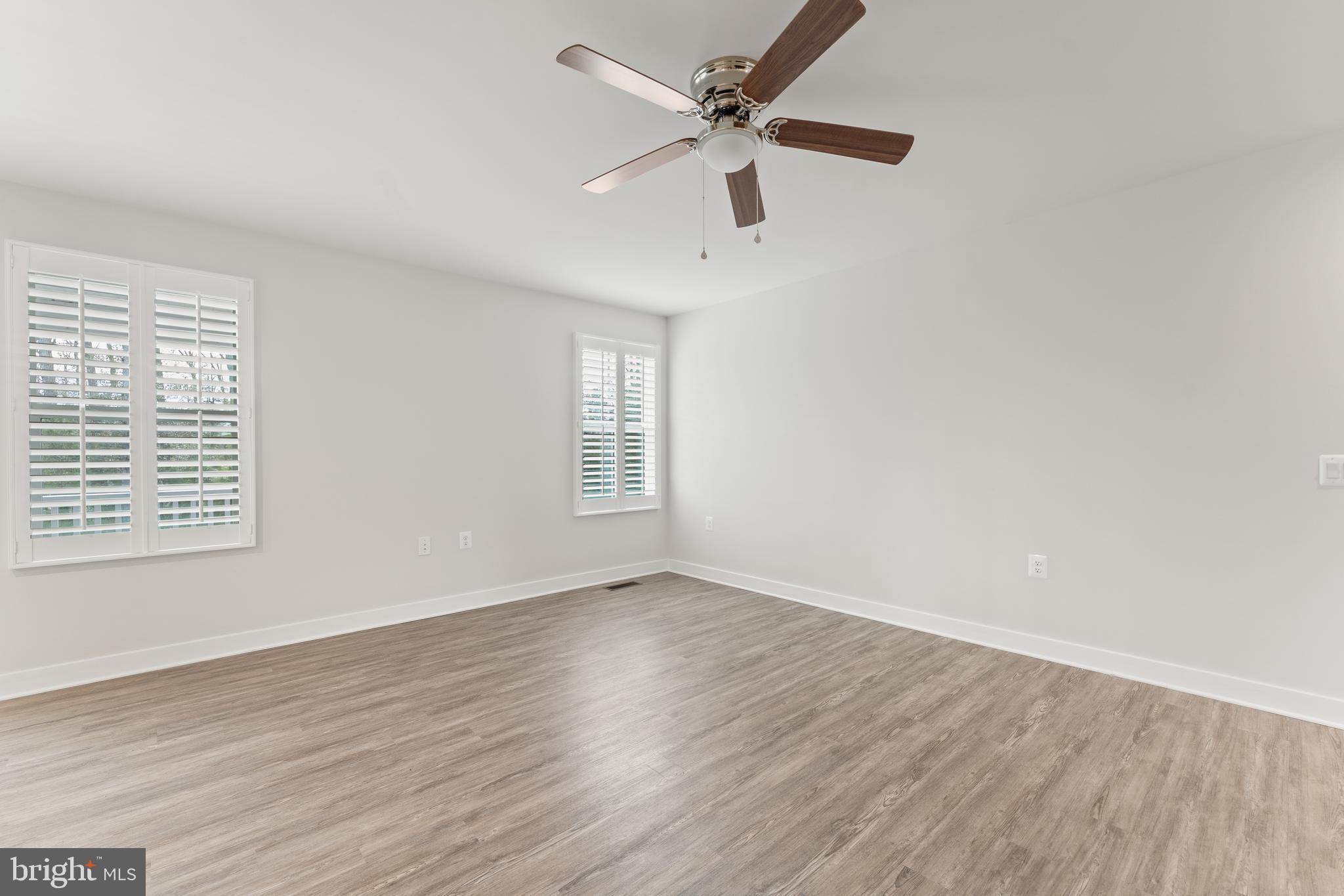 18332 Signature Way Ruther Glen, VA 22546 - Photo 13 of 50 an empty room with wooden floor fan and windows