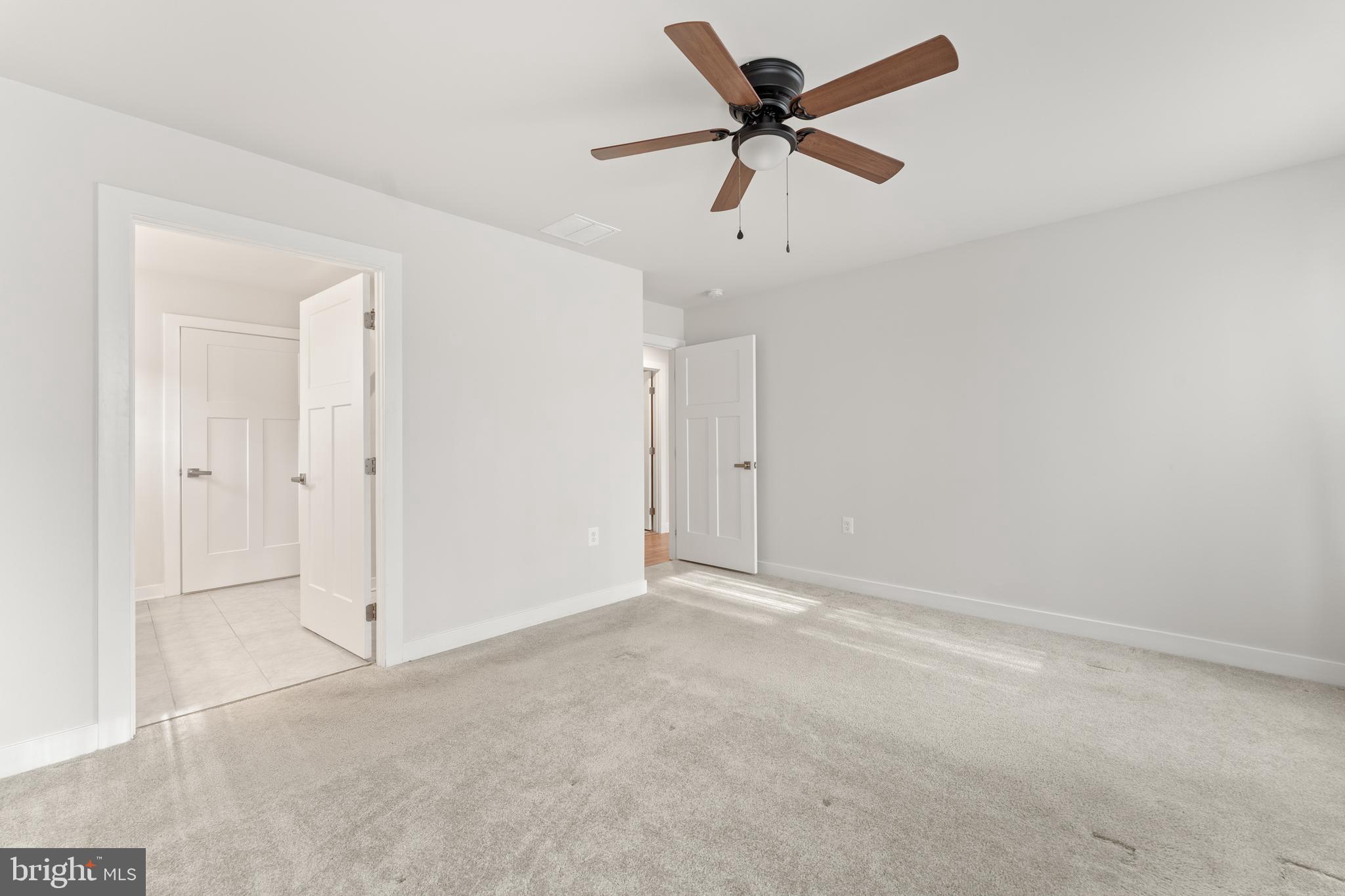 18332 Signature Way Ruther Glen, VA 22546 - Photo 17 of 50 an empty room with a ceiling fan and a window