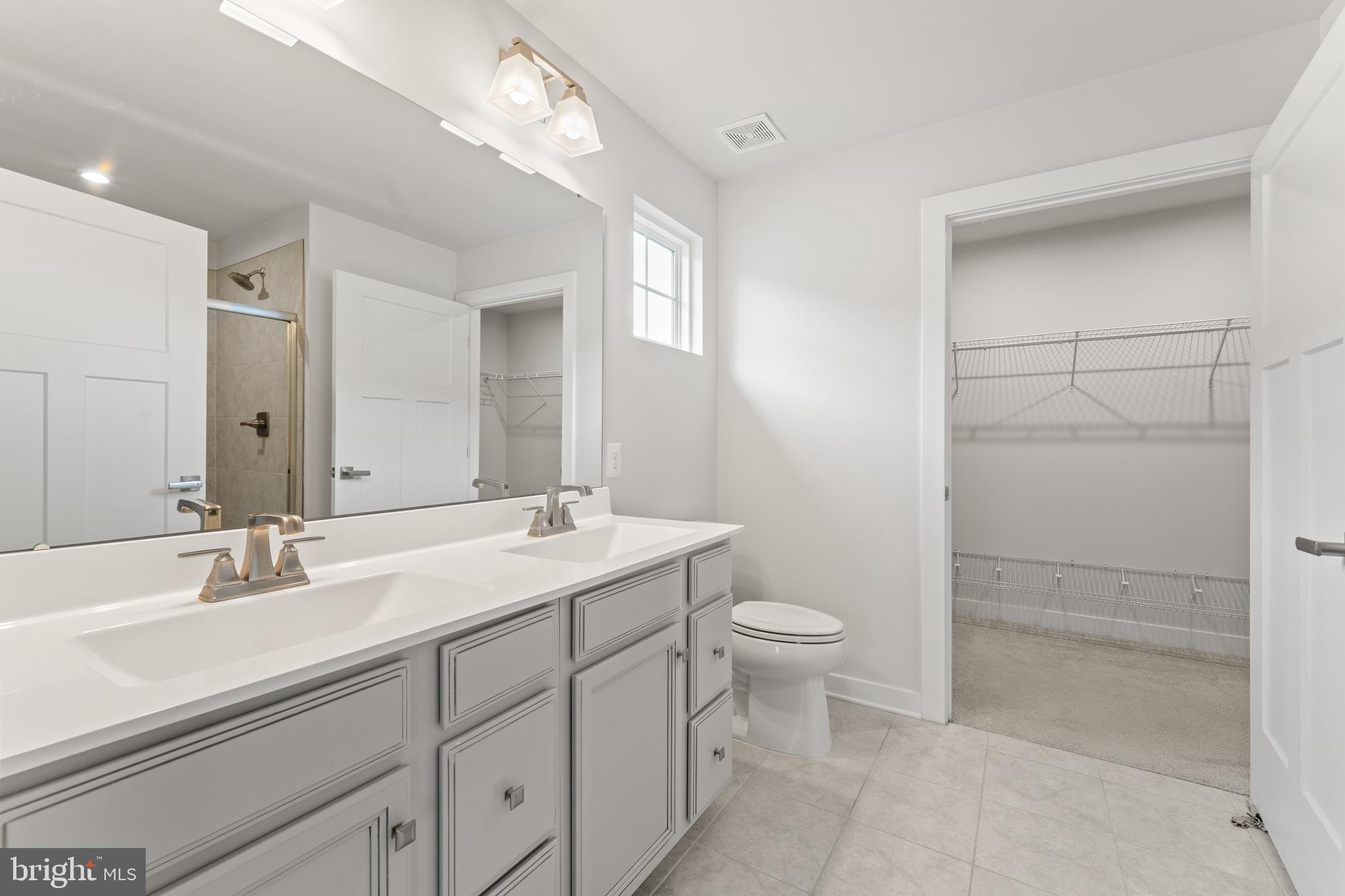 18332 Signature Way Ruther Glen, VA 22546 - Photo 18 of 50 a bathroom with a double vanity sink mirror and toilet