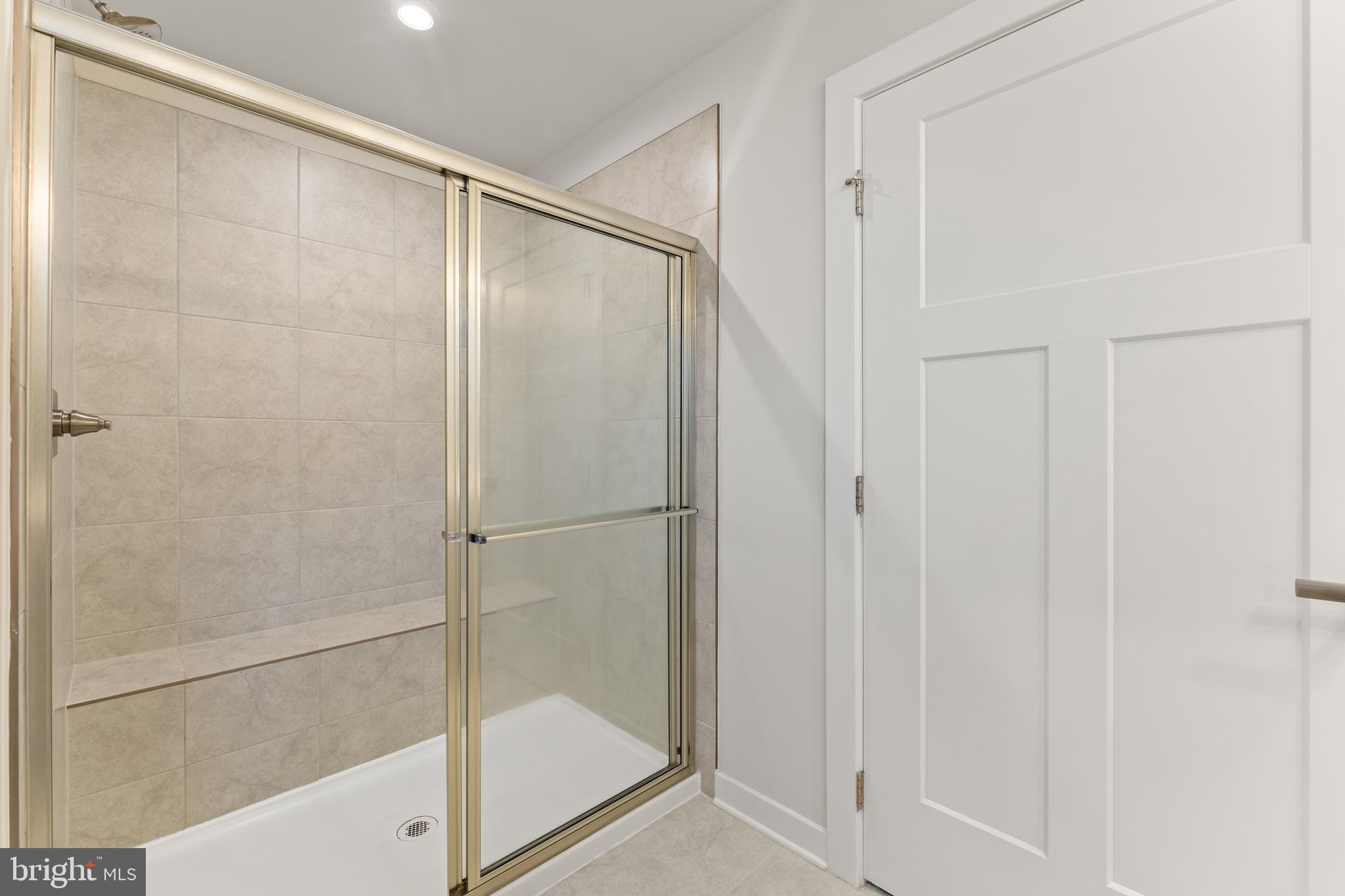 18332 Signature Way Ruther Glen, VA 22546 - Photo 19 of 50 a bathroom with a glass shower door