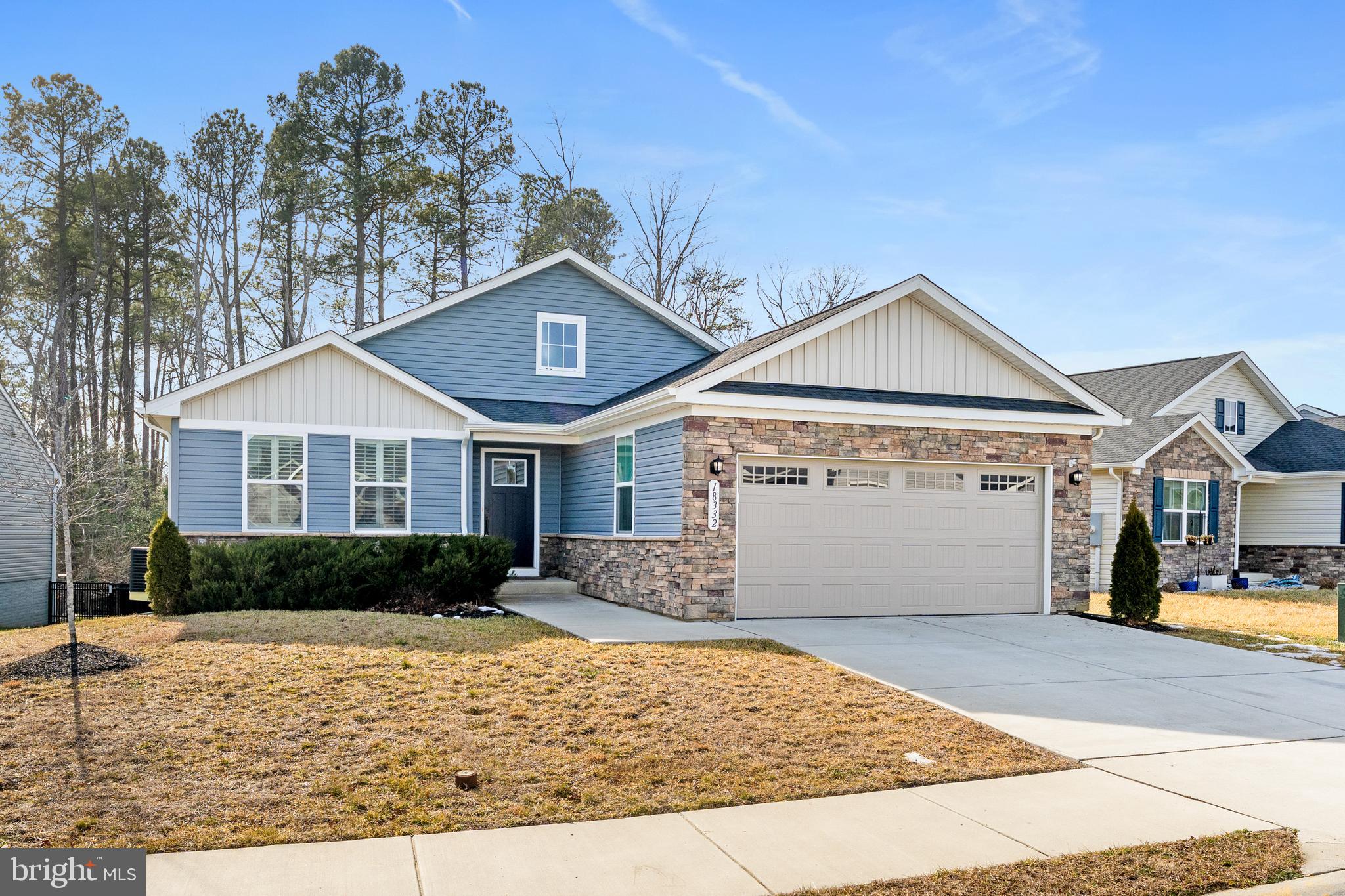 18332 Signature Way Ruther Glen, VA 22546 - Photo 2 of 50 a front view of a house with a yard and garage