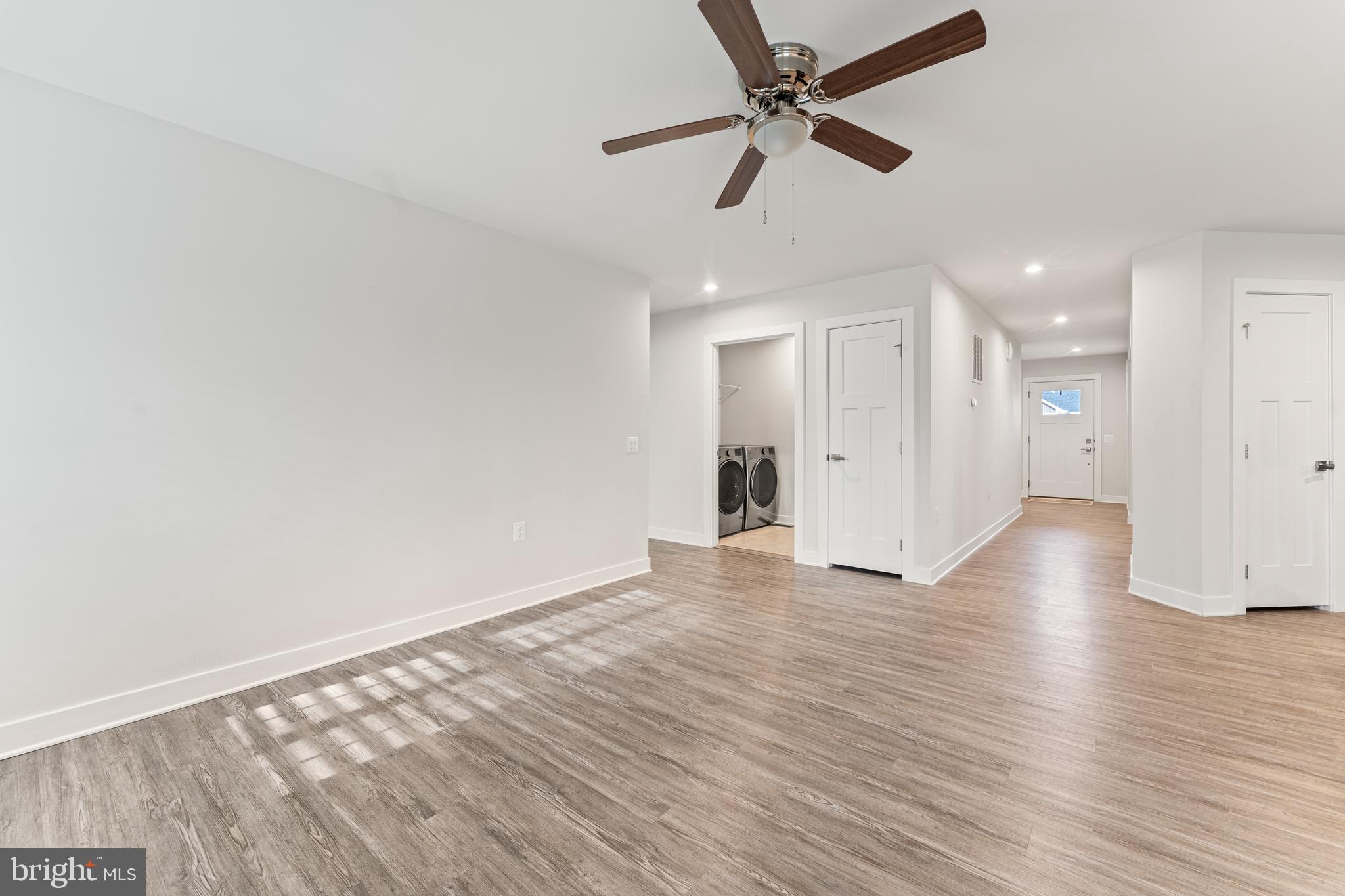 18332 Signature Way Ruther Glen, VA 22546 - Photo 22 of 50 an empty room with wooden floor fan and windows