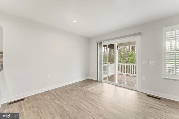 a view of kitchen with kitchen island white cabinets and stainless steel appliances