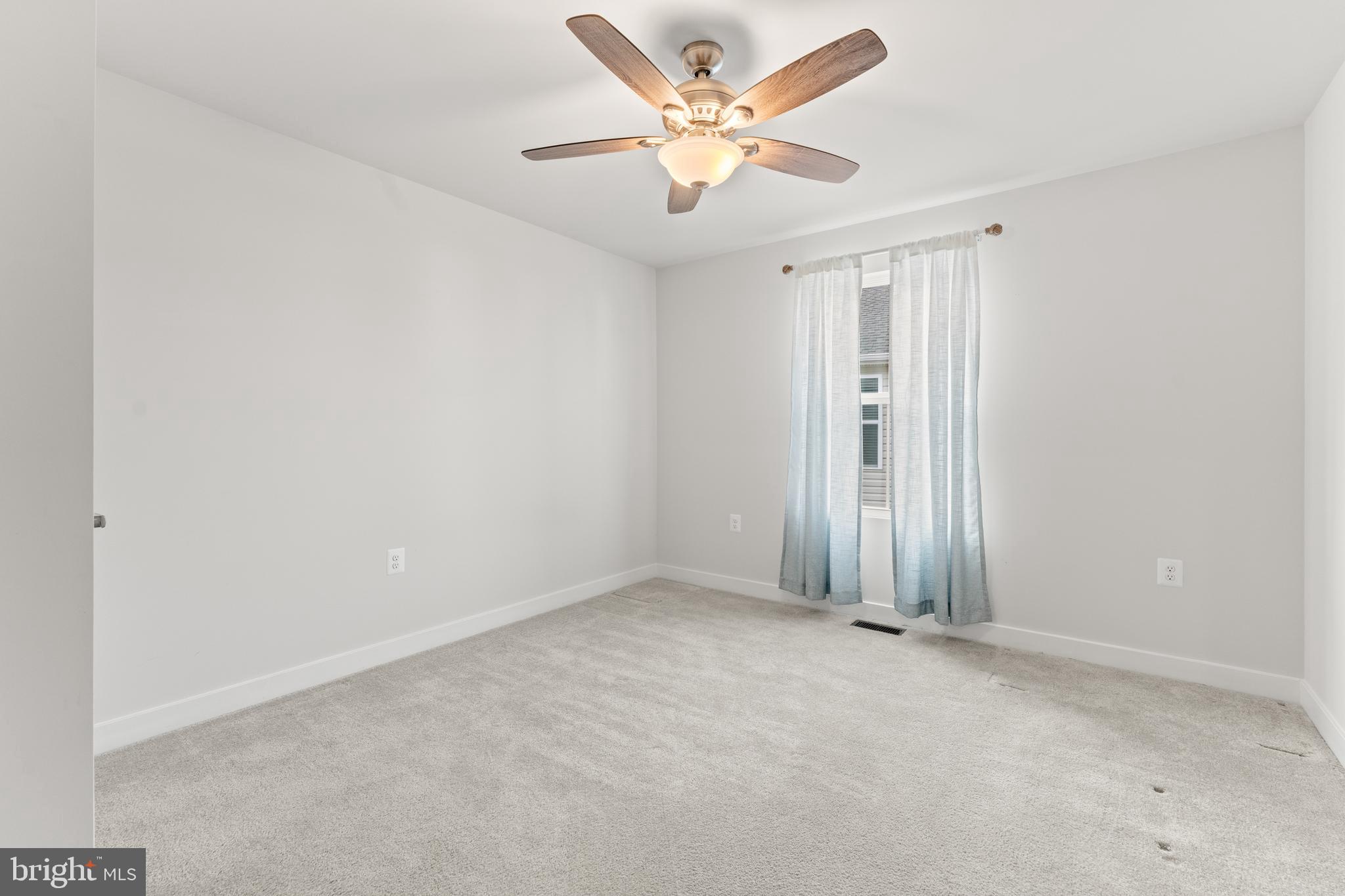 18332 Signature Way Ruther Glen, VA 22546 - Photo 5 of 50 an empty room with a ceiling fan and a window