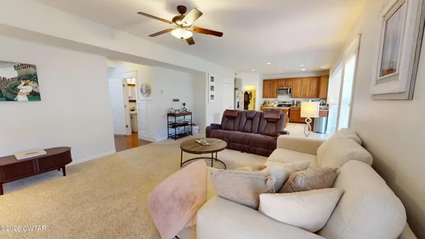a kitchen with granite countertop kitchen island stainless steel appliances a refrigerator sink and stove