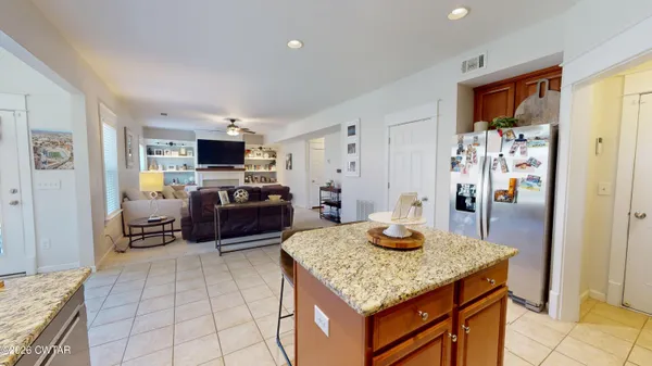 a kitchen with stainless steel appliances granite countertop a refrigerator and a stove