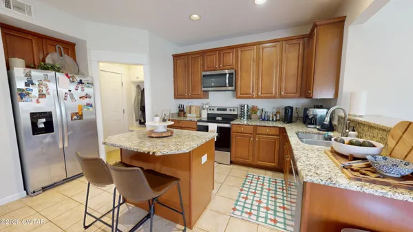a kitchen with a sink and wooden cabinets