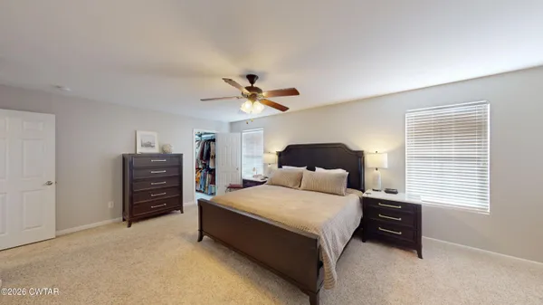 a view of walk in closet with clothes