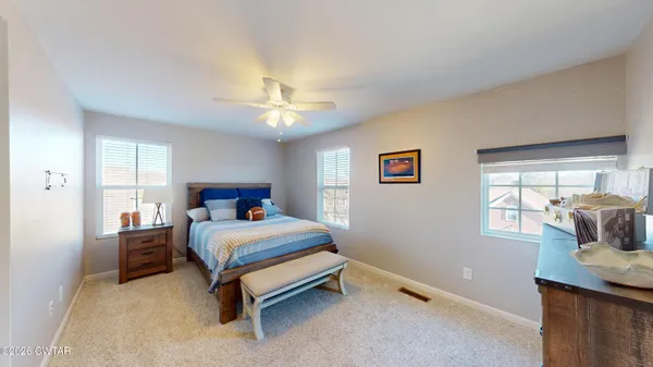 a bedroom with a bed and a dresser