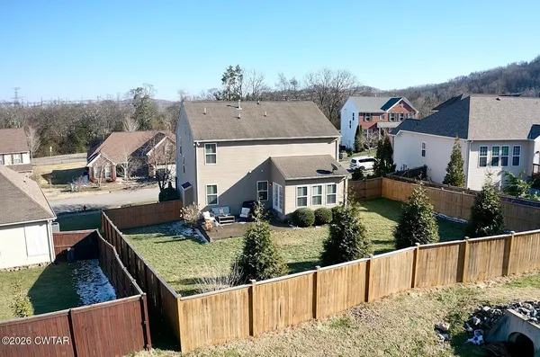 an aerial view of a house with a yard
