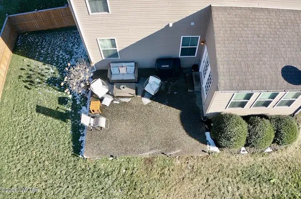 an aerial view of a house with garden space and street view