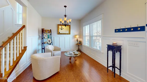 a living room with furniture and a chandelier