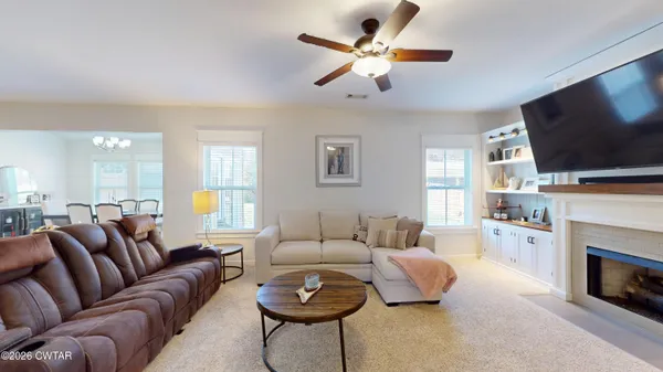 a living room with furniture and a fireplace