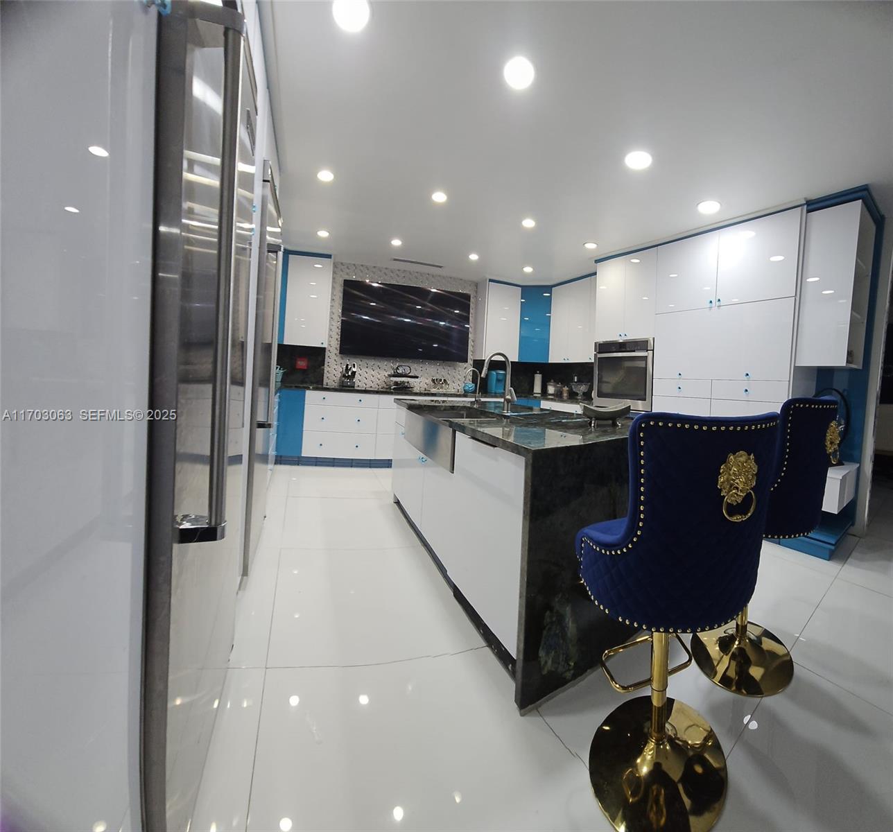 a kitchen with stainless steel appliances kitchen island granite countertop a sink and cabinets