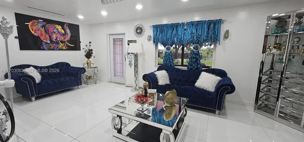 a living room with furniture and a flat screen tv