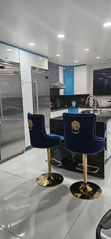 a kitchen with kitchen island granite countertop a stove and a refrigerator