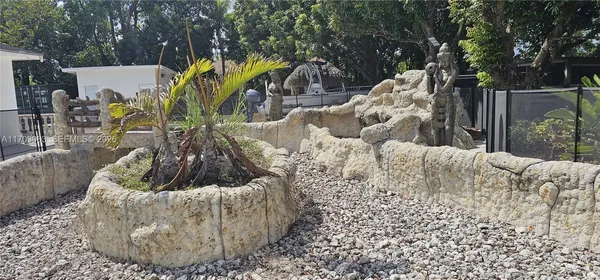 a garden with trees in the background