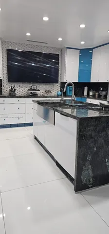 a kitchen with stainless steel appliances granite countertop a sink and a stove