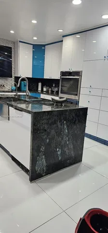 a kitchen with stainless steel appliances granite countertop a sink a stove and a refrigerator