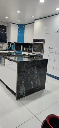 a kitchen with stainless steel appliances granite countertop a sink a stove and a refrigerator