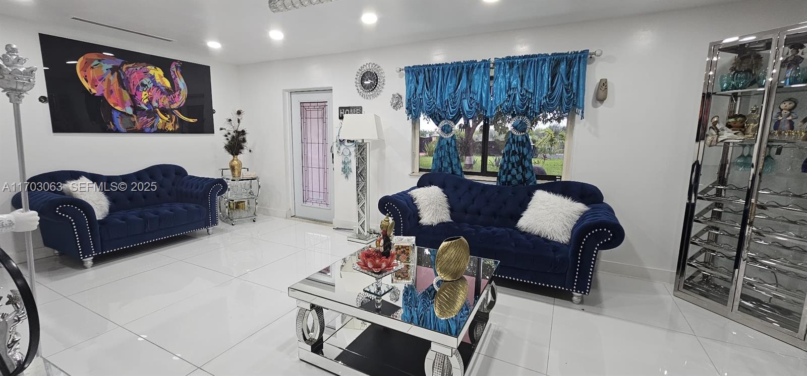 15700 Southwest 202nd Avenue Miami, FL 33187 - Photo 10 of 16 a living room with furniture a window and a flat screen tv