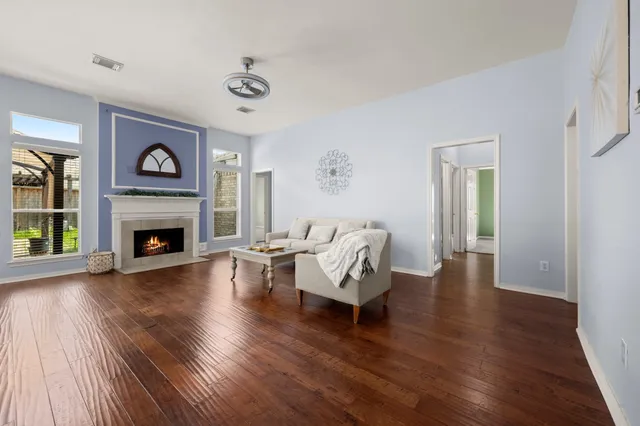 a living room with furniture and a fireplace