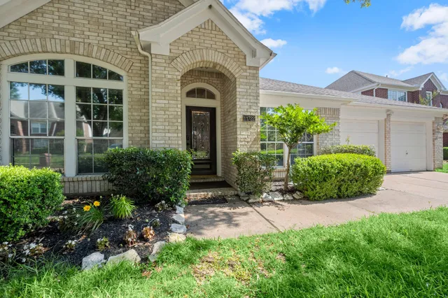 a front view of a house with a yard and outdoor seating
