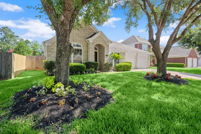 a front view of a house with garden