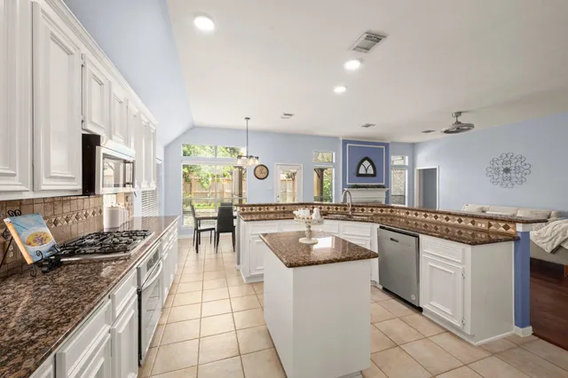 a kitchen with counter top space appliances and cabinets