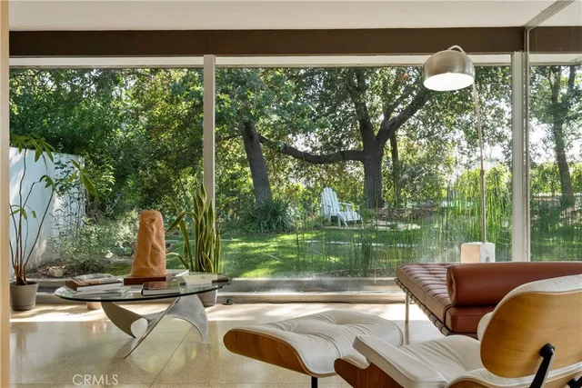 a view of a swimming pool with a patio and a yard