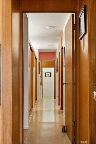a view of a hallway with wooden shelves