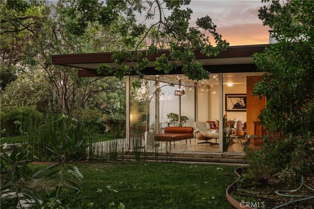 a view of two chairs in the garden