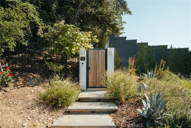 a view of a house with a tree in the background