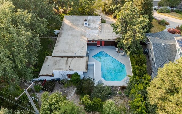 an aerial view of a house with a yard and garden