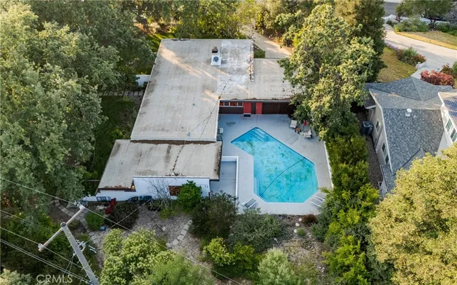 an aerial view of a house with a yard and garden