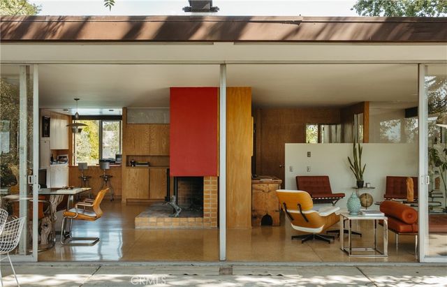 a living room with chairs and kitchen view