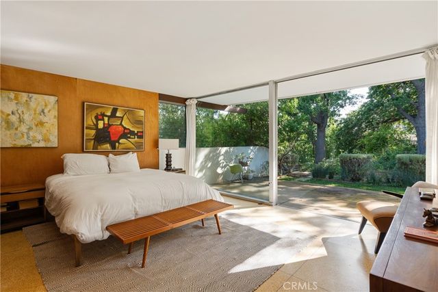 a bed room with a bed and glass door