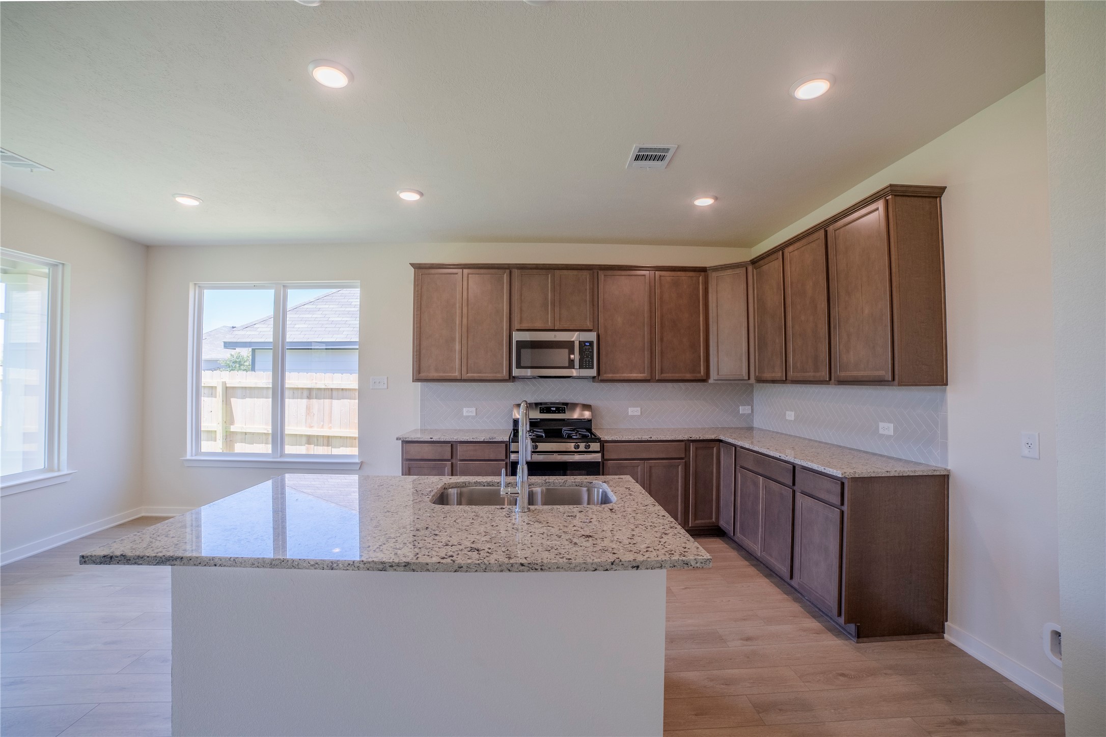 1402 Lk Rdg Drive Brenham, TX 77833 - Photo 19 of 35 a kitchen with stainless steel appliances granite countertop a sink stove and cabinets