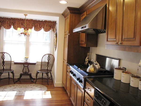 19 Appleby Road Wellesley, MA 02482 - Photo 6 of 18 a kitchen with a table chairs and a stove