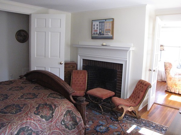 19 Appleby Road Wellesley, MA 02482 - Photo 8 of 18 a bedroom with a chair and a fireplace