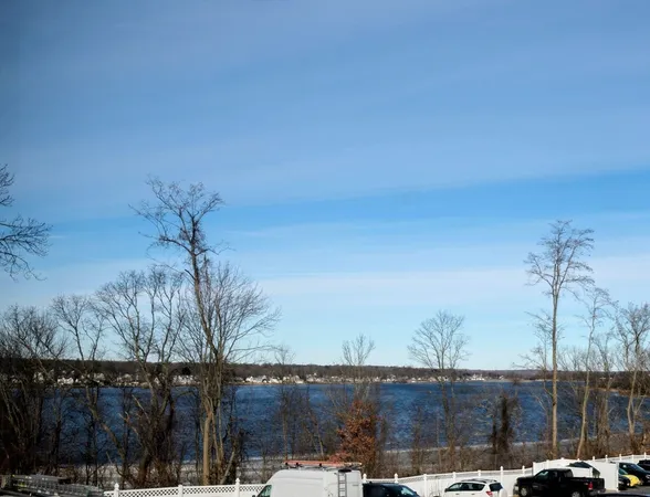 a kitchen with stainless steel appliances granite countertop a refrigerator a sink a stove a microwave oven with a refrigerator and cabinets