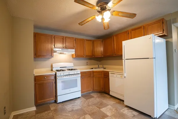 a kitchen with a stove a refrigerator and a sink