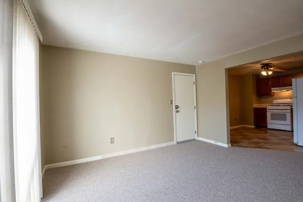 an empty room with closet area and bathroom