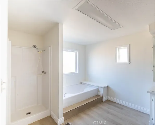 a bathroom with a bathtub and shower