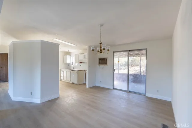 a view of a kitchen with a refrigerator and a sink