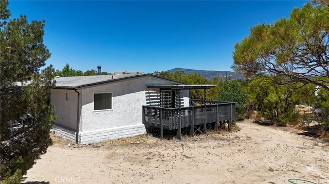 a view of a wooden deck with a yard