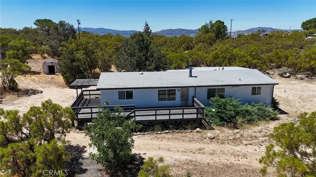 a view of a house with a yard and furniture